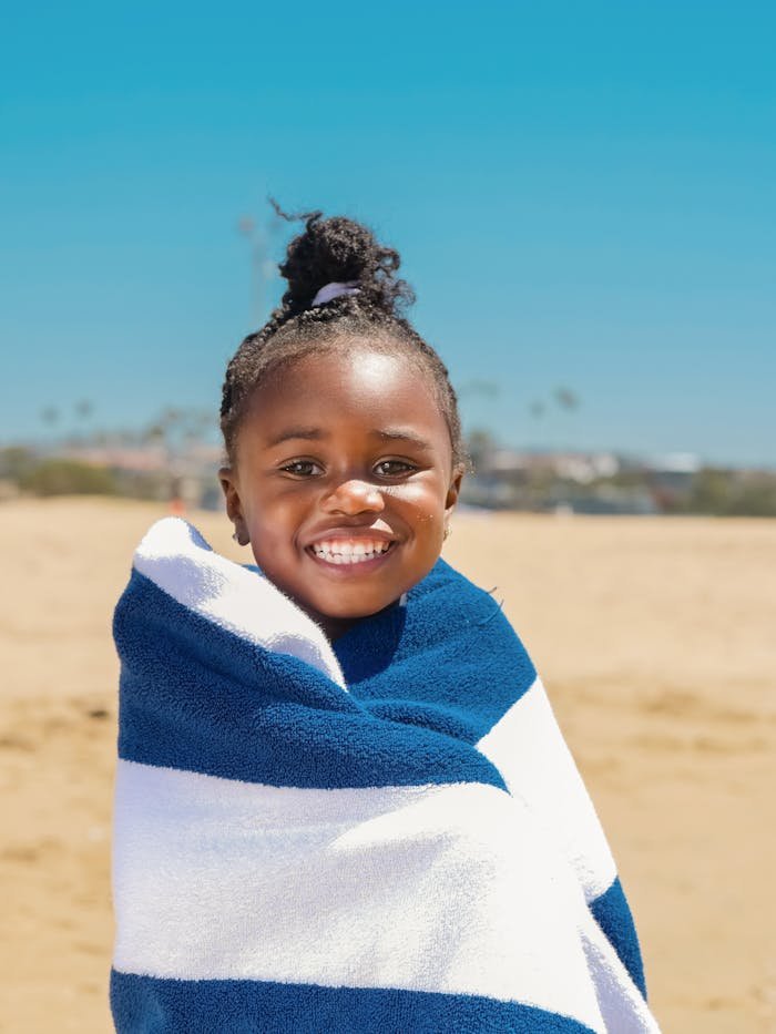 Little Girl in White and Blue Striped Towel Smiling